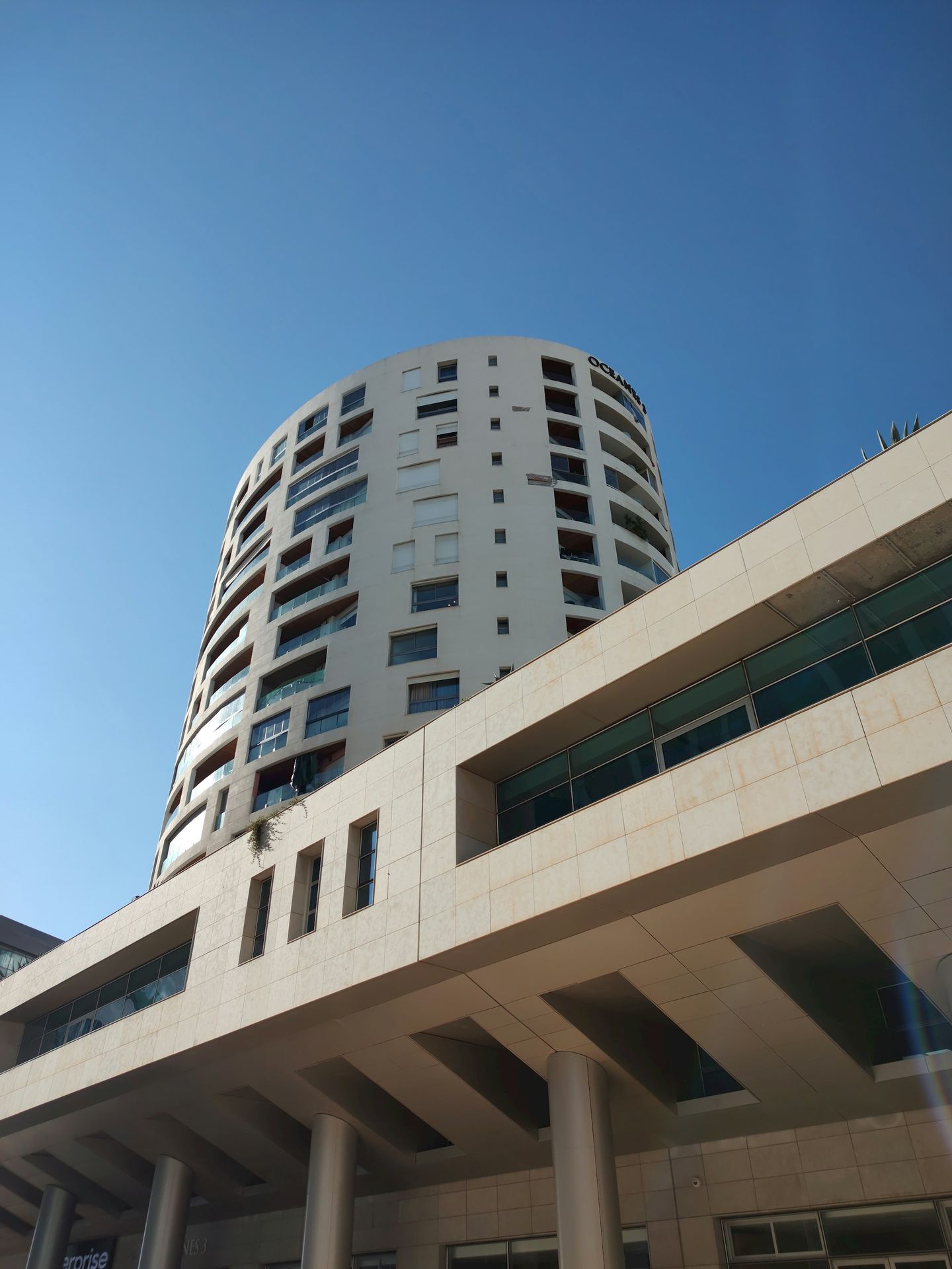 A tall white building with lots of windows